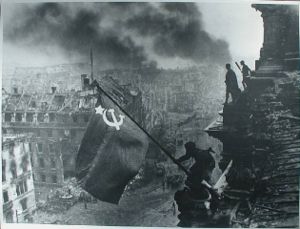 1945 – its the communist Russian troops raising the flag over the  Reichstag in Berlin